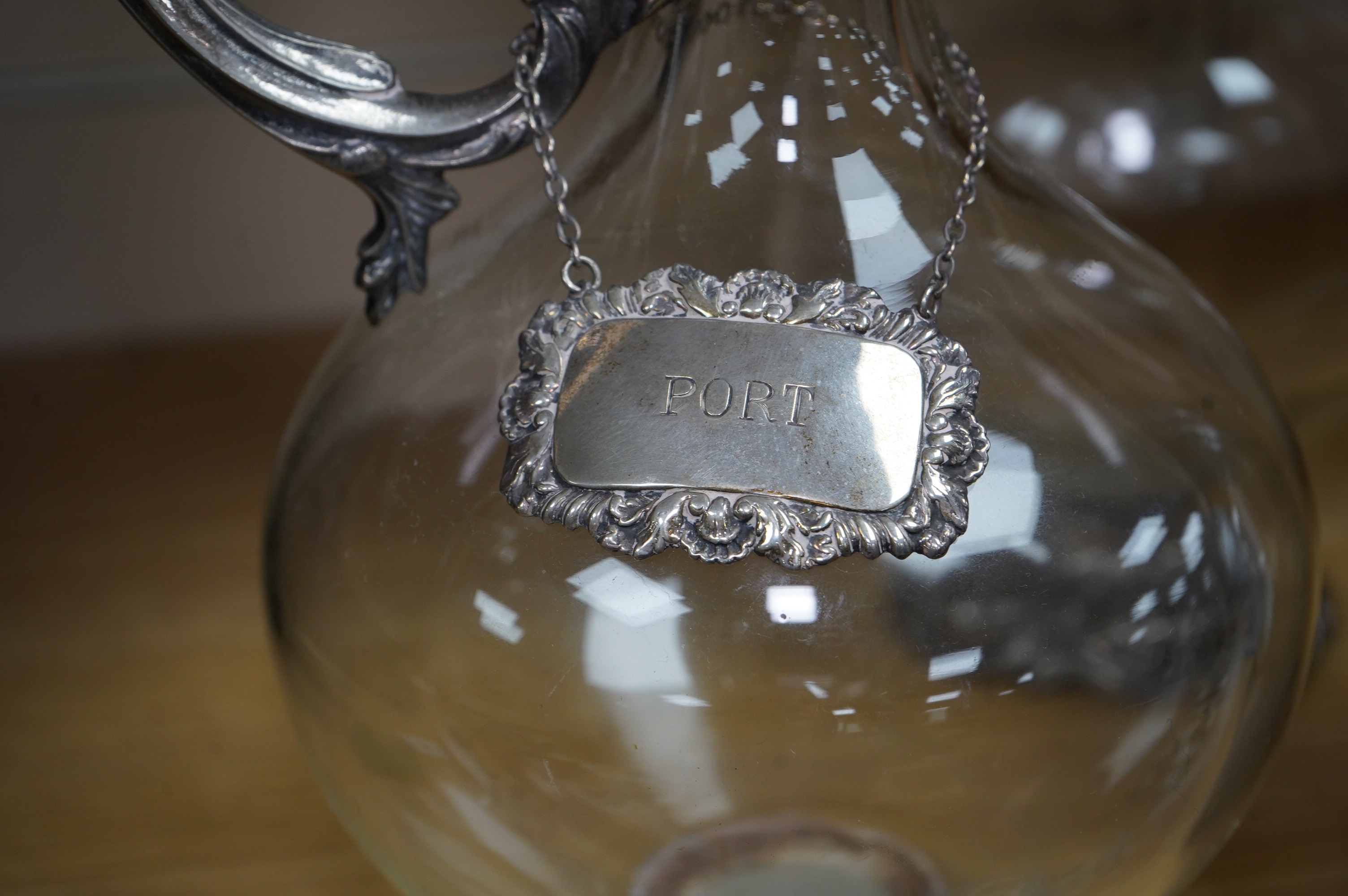 A pair of Art Nouveau silver plate mounted claret jugs with labels, 32cm. Condition - fair to good